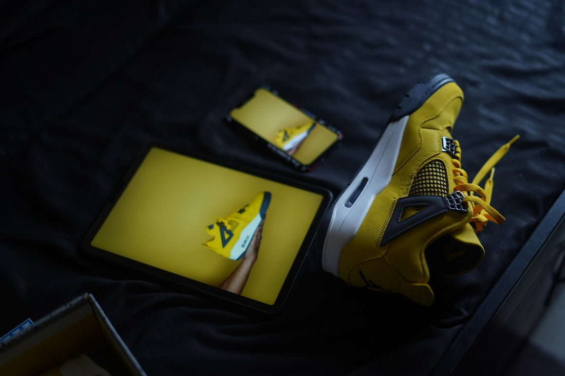 a pair of yellow sneakers sitting on top of a table